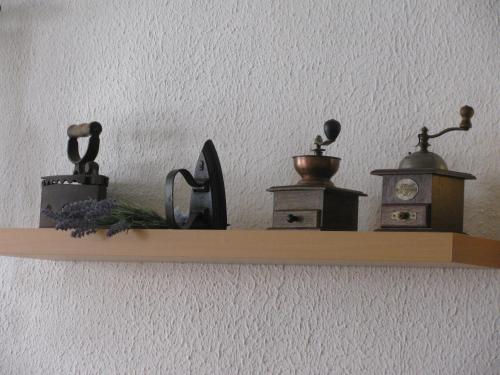 a shelf with three appliances sitting on a wall at Hotel Kilian in Braunlage