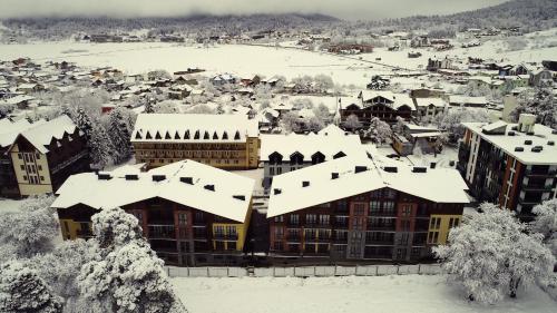 a town covered in snow with buildings at Bakuriani Park Residence Apartment #3 in Bakuriani