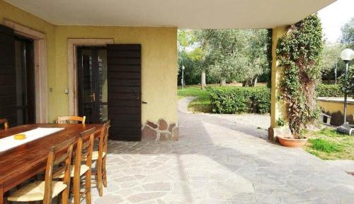 a patio with a table and chairs and a house at AGRITURISMO MELOGRANO D'ORO in Bardolino
