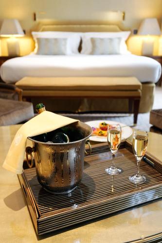 a table with a tray with a bucket and two glasses at Hotel Le Plaza Brussels in Brussels