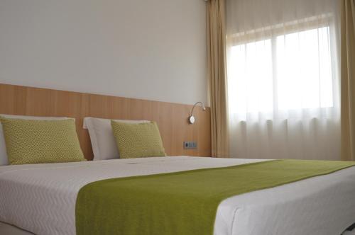 Postel nebo postele na pokoji v ubytování Hotel Da Luz