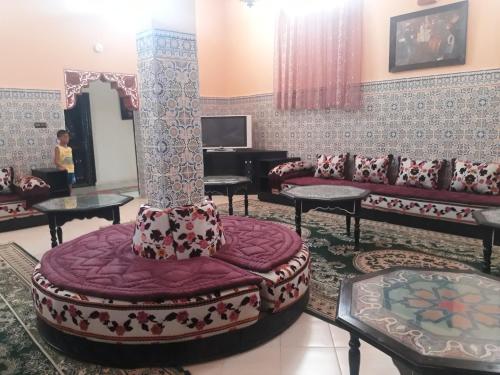 a living room with a large couch and a chair at Almounia Hotel & Spa in Taroudant