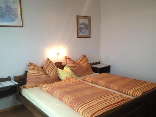 a bedroom with a bed with two pillows on it at Alpengasthaus Sonnhof in Goding