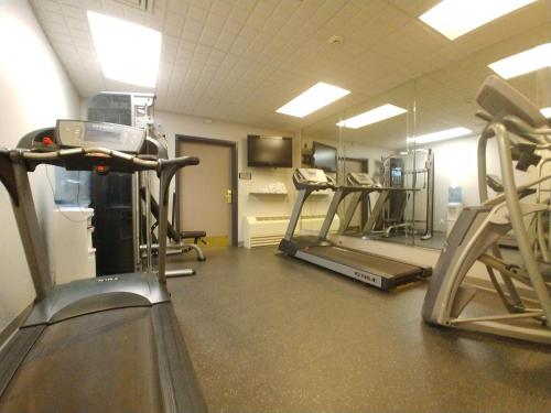 a gym with several tread machines in a room at Country Inn & Suites by Radisson, Freeport, IL in Freeport