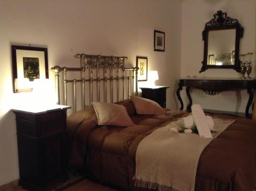 a bedroom with a large bed and a mirror at Verdi Apartment in Castellammare del Golfo
