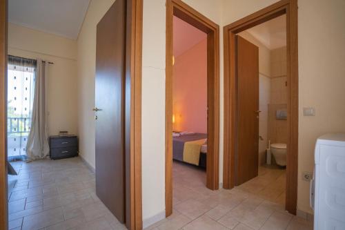 a hallway with a room with a bed and a bathroom at Villa Katerina in Siviri