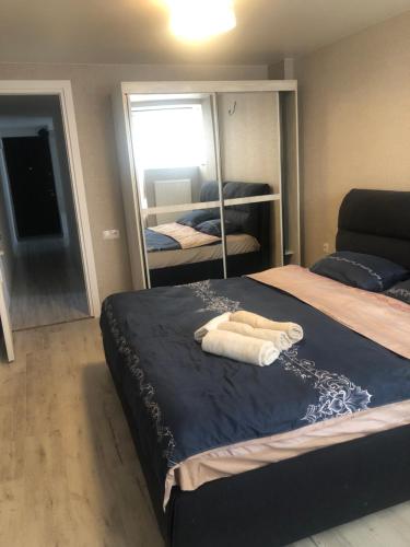 a bedroom with a large bed with a mirror at Dona Palace Apartments in Tbilisi City