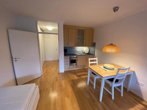 a kitchen and dining room with a table and chairs at The Alpine Ridge Apartment in Garmisch-Partenkirchen
