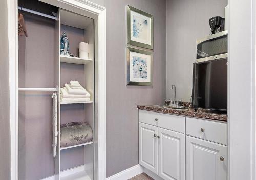 een badkamer met een wastafel en een spiegel bij Suites At 143 Arlington Street in Boston