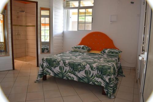 a small room with a bed and a window at Lokation gwada in Sainte-Anne