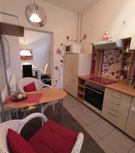 a kitchen with a table and a dining room at Arador-City Hotel in Bad Oeynhausen