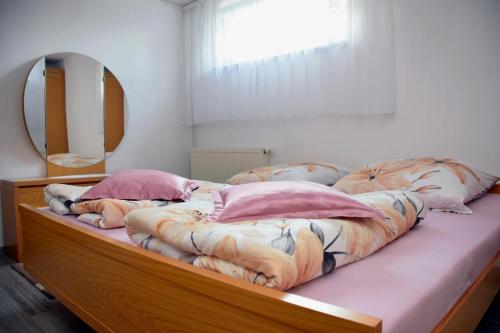 a bedroom with a large bed with a large mirror at FeWo Afferde in Hameln