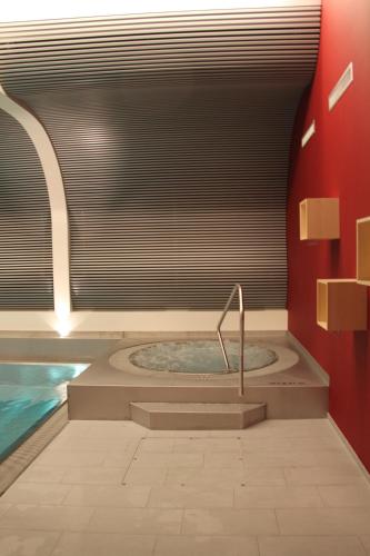 a bathroom with a jacuzzi tub in a room at Le Mirabeau Resort & Spa in Zermatt
