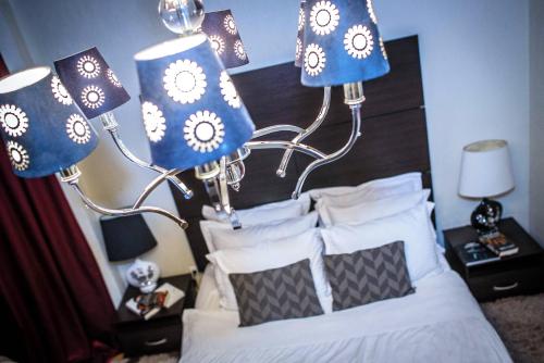 - une chambre dotée d'un lit avec des lampes bleues et blanches dans l'établissement ORNAVA Boutique Apartments, à Ternopil