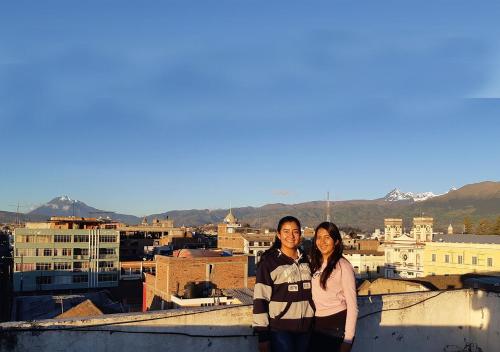 two women standing on the roof of a building at La Merced Plaza Hospedaje in Riobamba