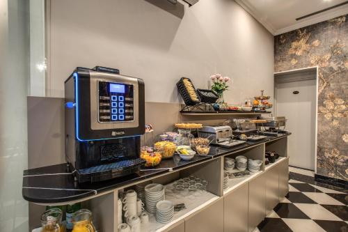 a coffee shop with a coffee machine on display at Relais De La Poste in Rome