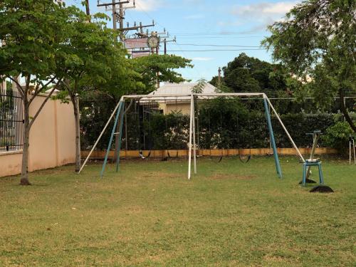 an empty swing set in a yard at Dawn’s Comfort Zone in Kingston