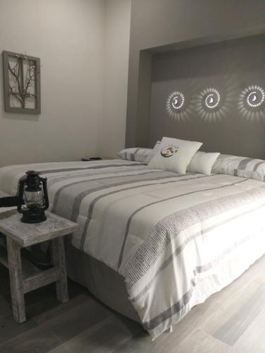 a bedroom with a large bed and a table at Casa AMMAH in Ciudad Valles
