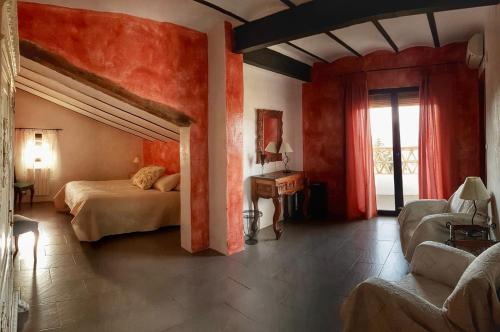 a bedroom with a bed and a large window at Hotel Finca Aldabra in Pinos Genil