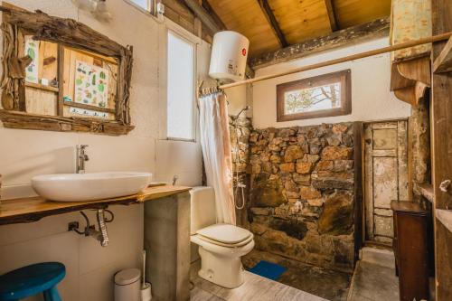 a bathroom with a sink and a toilet in a room at La Cabañita de José Ignacio in José Ignacio