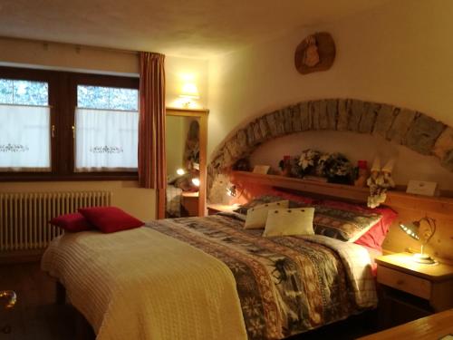 a hotel room with a bed and a window at Haus Green & Spa Angelika Trentino in Lavarone