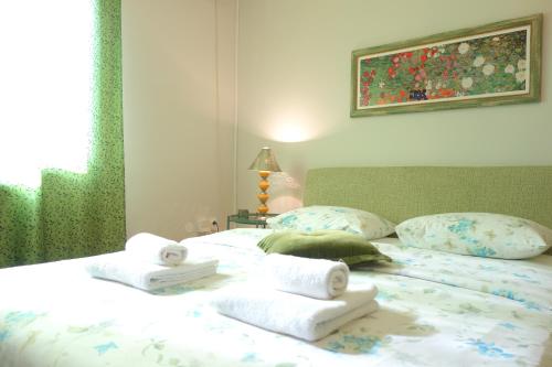a bedroom with a bed with towels on it at Villa Quantum Beograd in Belgrade