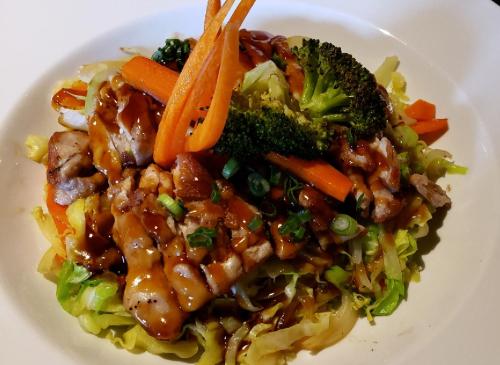a white plate of food with meat and vegetables at Quality Inn Merritt in Merritt