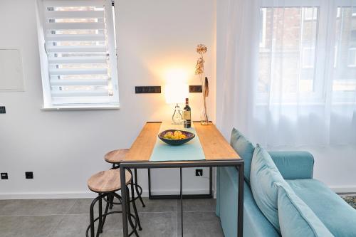 a dining room table with a bowl of fruit on it at City Apartments Hannover in Hannover
