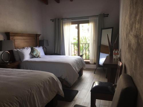 En eller flere senge i et værelse på Hotel Concierge Flor y Canto