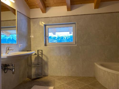 a bathroom with a sink and a tub and a window at Naturerlebnis am Glungezer-Haus-8 Pax in Tulfes