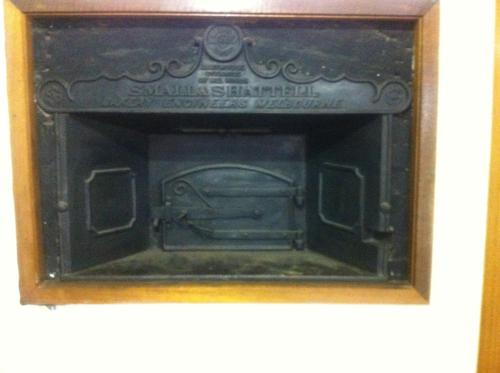 a picture of a fireplace in a wooden frame at Bakery Park Motor Inn in Tocumwal