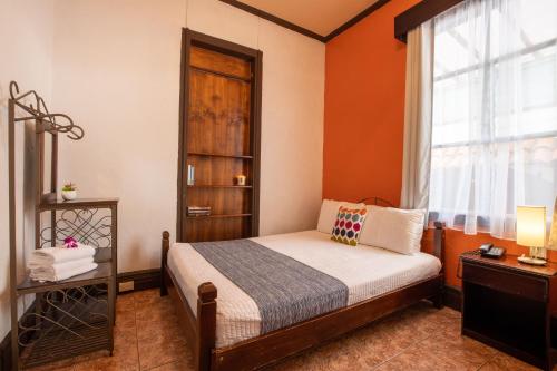 a bedroom with a bed and a window at ALAJUELA CITY Hotel & Guest House in Alajuela City