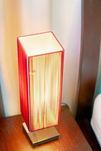 a red box sitting on top of a wooden table at Baan Sandao Condo in Hua Hin