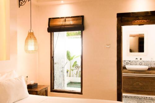 Кровать или кровати в номере The Mandana Villa Gili Air