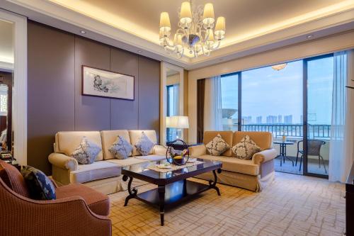 a living room with couches and a chandelier at Your World International Conference Centre Hotel in Yiwu