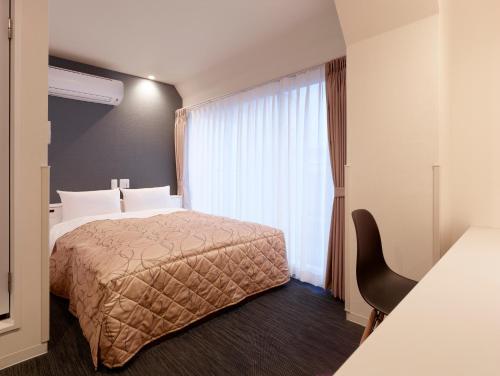 Postel nebo postele na pokoji v ubytování Hotel New Tohoku
