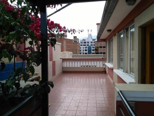 an empty corridor of a building with a balcony at Residencial Mariloy in Cochabamba
