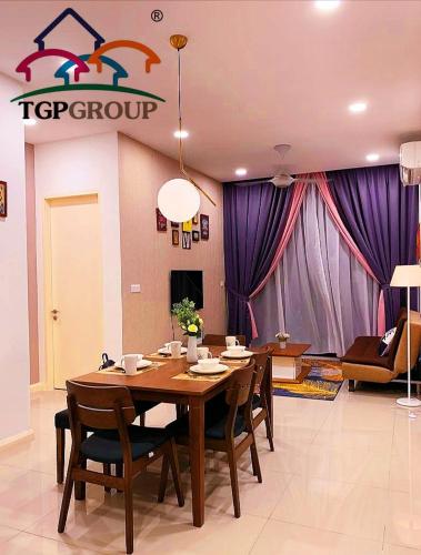 a dining room with a table and some purple curtains at Legoland D'PRISTINE Apartment By TGP in Nusajaya