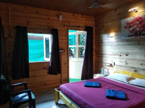 a bedroom with a bed in a wooden room at Samsun Pride in Chaoka
