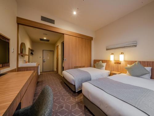 Ένα ή περισσότερα κρεβάτια σε δωμάτιο στο Sapporo View Hotel Odori Park