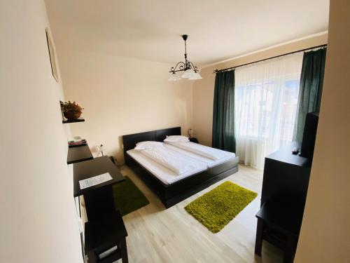 a bedroom with a bed and a large window at Vila Old Cars in Cristian