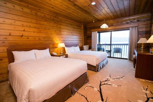 Un pat sau paturi într-o cameră la The Richforest Hotel- Sun Moon Lake