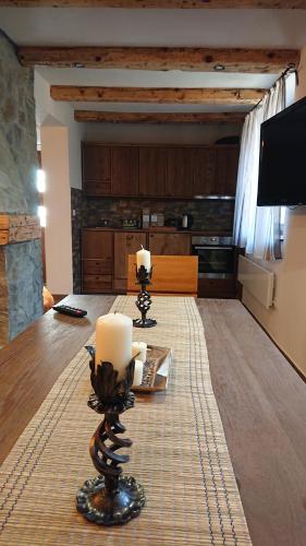 a living room with two candles on a table at Plitvički San in Korenica