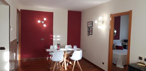 a dining room with a white table and white chairs at Pegasus Hotel in Sassari