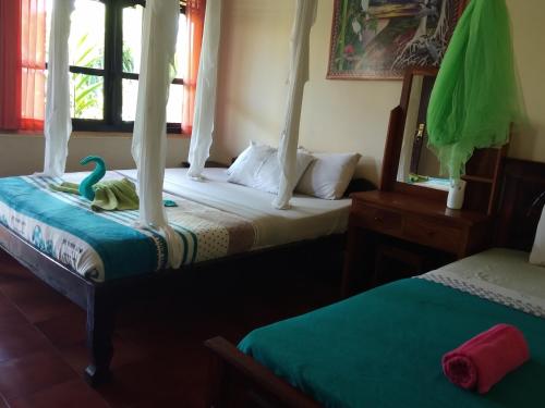 a bedroom with two beds with a swan on the bed at Volcano Living in Kintamani