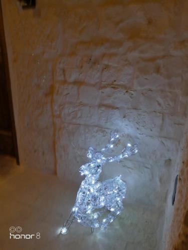 a glass christmas tree sitting on the floor at B&b I Trulli dei Desideri in Alberobello