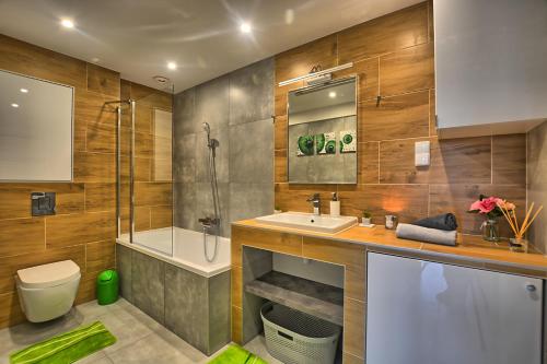 a bathroom with a sink and a shower and a toilet at Apartament Diamentowy in Lesko