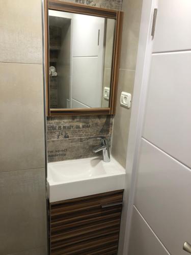 a bathroom with a sink and a mirror at Buchman apartment near center in Modi‘in