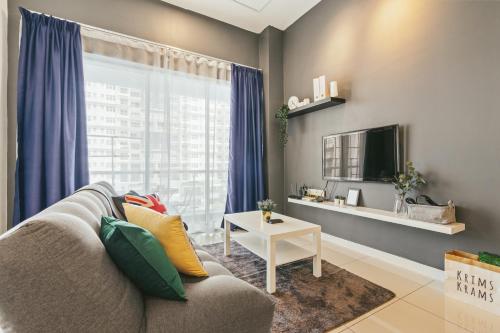 a living room with a couch and a tv at Puchong Skypod Residence, 1-5 pax with Balcony Unit, Walking Distance to IOI Mall, 10min Drive to Sunway in Puchong