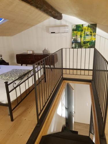 a room with a staircase and a bed in a room at Domus Alba Lenno in Lenno